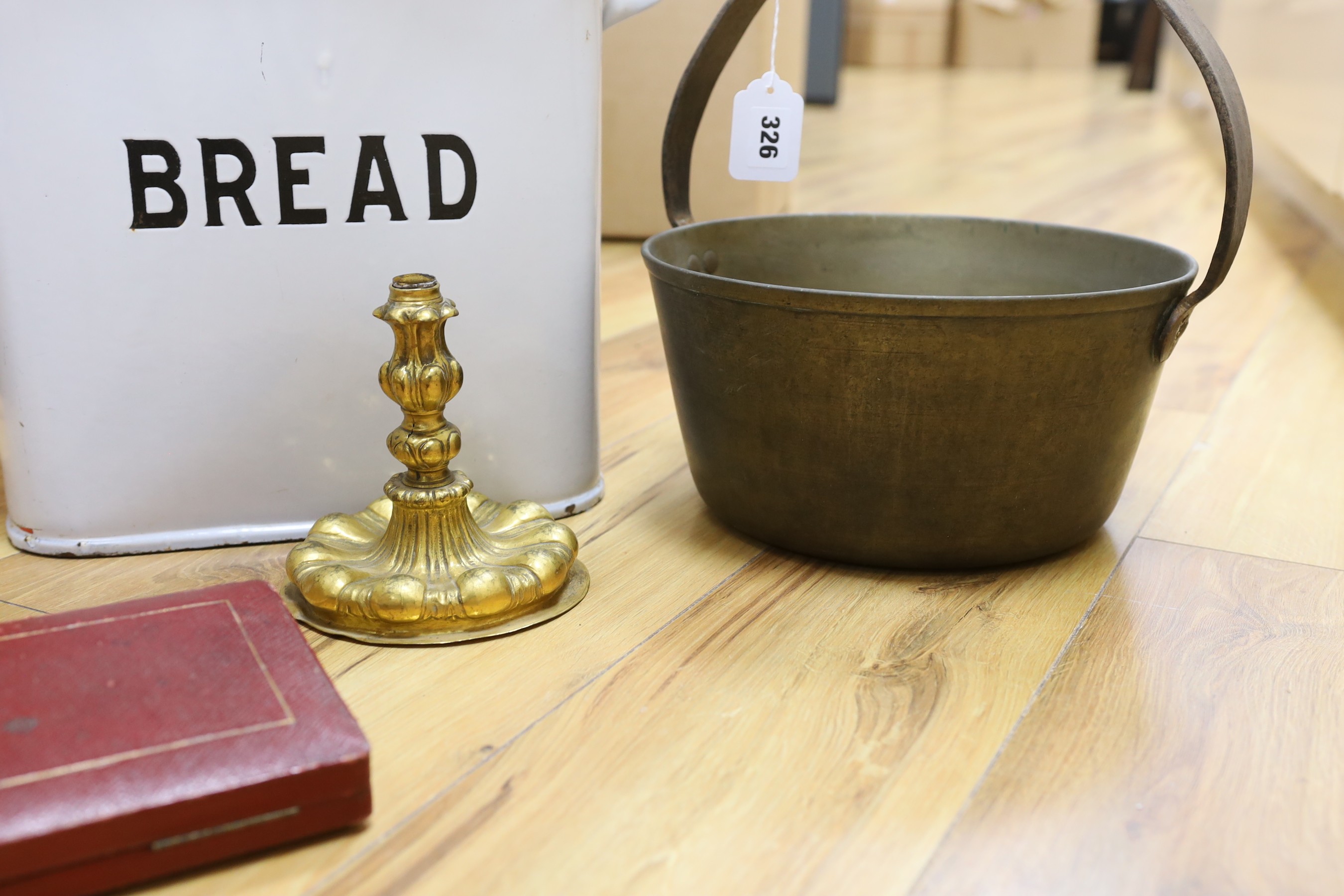 A brass cooking pot, a gilt metal candlestick, an enamel bread bin and cased fish servers